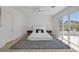 Modern bedroom with a ceiling fan and glass doors to the balcony at 5271 Villa Vecchio Ct, Las Vegas, NV 89141