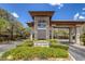 Stone community entrance with manicured landscaping and clear signage, framed by mature trees and a blue sky at 5271 Villa Vecchio Ct, Las Vegas, NV 89141