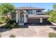 Elegant two-story home with arched entryway, a three-car garage, and beautiful landscaping at 5271 Villa Vecchio Ct, Las Vegas, NV 89141