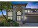 Beautiful two-story home with impressive arched entryway and lush landscaping at 5271 Villa Vecchio Ct, Las Vegas, NV 89141