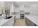 Spacious kitchen with white countertops, modern backsplash, stainless steel appliances, and ample cabinetry at 5271 Villa Vecchio Ct, Las Vegas, NV 89141