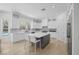 Well-appointed kitchen featuring white cabinets, a gray island, and stainless steel appliances at 5271 Villa Vecchio Ct, Las Vegas, NV 89141