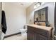 Bathroom featuring a vanity with dark wood cabinetry and a cream-colored sink at 5385 Ravendale Cir, Las Vegas, NV 89120