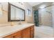 Modern bathroom with a single sink vanity, bathtub, and shower combination at 5385 Ravendale Cir, Las Vegas, NV 89120