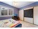 Charming bedroom featuring natural light from a bright window and a closet with sliding doors at 5385 Ravendale Cir, Las Vegas, NV 89120