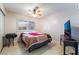 Cozy bedroom with neutral walls, tiled flooring, and a window providing natural light at 5385 Ravendale Cir, Las Vegas, NV 89120