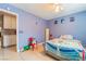 Brightly painted bedroom featuring a single bed, built-in cabinets, and playful decor at 5385 Ravendale Cir, Las Vegas, NV 89120