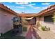 Private courtyard with desert landscaping, featuring a unique barrel table with seating and tiled walkway at 5385 Ravendale Cir, Las Vegas, NV 89120