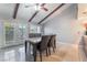 Inviting dining room featuring a modern table set, beamed ceiling, and tile floors, with natural light at 5385 Ravendale Cir, Las Vegas, NV 89120