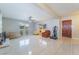 Bright living room featuring tile floors, a stone fireplace, and large windows with plantation shutters at 5385 Ravendale Cir, Las Vegas, NV 89120