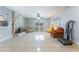 Spacious living room features tile floors, a stone fireplace, and bright natural light from surrounding windows at 5385 Ravendale Cir, Las Vegas, NV 89120