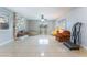 Spacious living room features tile floors, a stone fireplace, and bright natural light from surrounding windows at 5385 Ravendale Cir, Las Vegas, NV 89120