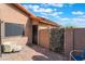 Secluded outdoor patio area featuring secure gated door and desert landscaping at 5385 Ravendale Cir, Las Vegas, NV 89120