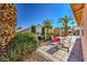 Landscaped backyard with patio and outdoor seating at 5452 Green Palms St, Las Vegas, NV 89130