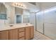 Bathroom featuring dual sinks and a glass-enclosed shower at 5452 Green Palms St, Las Vegas, NV 89130