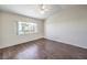 Bright bedroom with hardwood floors, a ceiling fan, and a large window at 5452 Green Palms St, Las Vegas, NV 89130