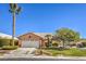 Charming single-story home featuring a two-car garage, mature landscaping, and a well-maintained front yard at 5452 Green Palms St, Las Vegas, NV 89130