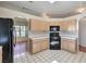 Corner kitchen with tile countertops and modern black appliances at 5452 Green Palms St, Las Vegas, NV 89130