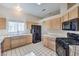 Bright kitchen with tiled countertops and modern black appliances at 5452 Green Palms St, Las Vegas, NV 89130