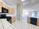 Corner kitchen with tiled countertops and black appliances at 5452 Green Palms St, Las Vegas, NV 89130