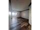 Bright living room featuring wood-look floors and sliding glass doors to a balcony at 5525 W Flamingo Rd # 1020, Las Vegas, NV 89103