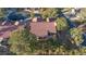 An aerial view of a single Gathering home featuring a tile roof, patio, and mature landscaping at 5601 Cavalier Cir, Las Vegas, NV 89130