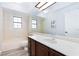 Bright bathroom featuring a vanity with a large mirror and a tub with shower at 5601 Cavalier Cir, Las Vegas, NV 89130