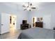 Spacious bedroom featuring wood floors, ceiling fan, and neutral paint at 5601 Cavalier Cir, Las Vegas, NV 89130