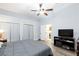 Cozy bedroom featuring wide closet, wood floors, and a television at 5601 Cavalier Cir, Las Vegas, NV 89130