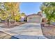 Charming single-story home featuring a long driveway leading to a two car garage at 5601 Cavalier Cir, Las Vegas, NV 89130