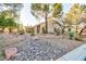 Desert landscaping and a decorative stone garden bed add curb appeal to this single-story home at 5601 Cavalier Cir, Las Vegas, NV 89130