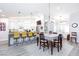 Open concept kitchen with dining area featuring a large island, white cabinetry, and stylish pendant lighting at 5601 Cavalier Cir, Las Vegas, NV 89130