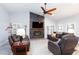 Cozy living room featuring a fireplace, ceiling fan, and comfortable seating, perfect for relaxing at 5601 Cavalier Cir, Las Vegas, NV 89130