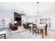 Open-concept living room with fireplace, ceiling fan, and dining area, showcasing modern design at 5601 Cavalier Cir, Las Vegas, NV 89130