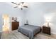 Spacious main bedroom with a ceiling fan, dresser, and wood-look flooring at 5601 Cavalier Cir, Las Vegas, NV 89130