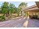 Cozy covered patio with outdoor seating and views of the landscaped backyard at 5601 Cavalier Cir, Las Vegas, NV 89130