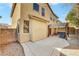 Expansive backyard featuring a covered patio, desert landscaping, and the home's stucco exterior at 5976 Ancona Dr, Las Vegas, NV 89141