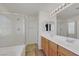 Bright bathroom featuring a double sink vanity and glass enclosed tub-shower at 5976 Ancona Dr, Las Vegas, NV 89141