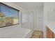 Bathroom featuring a soaking tub, shower, and a window providing natural light at 5976 Ancona Dr, Las Vegas, NV 89141