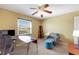 Tan bedroom with a work desk and comfortable seating area at 5976 Ancona Dr, Las Vegas, NV 89141