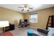 Tan bedroom featuring a ceiling fan, work desk, and comfortable seating at 5976 Ancona Dr, Las Vegas, NV 89141