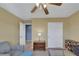 Well-lit bedroom with a ceiling fan, closet and doorway leading to a living space at 5976 Ancona Dr, Las Vegas, NV 89141