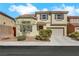 Charming two-story home with tile roof, neutral siding, and a well-maintained front yard at 5976 Ancona Dr, Las Vegas, NV 89141