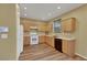 Bright kitchen with light cabinets, white appliances, and wood-look flooring at 5976 Ancona Dr, Las Vegas, NV 89141