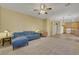 Comfortable living room featuring a couch, carpeting, and ceiling fan at 5976 Ancona Dr, Las Vegas, NV 89141