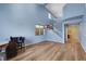 Open-concept living area with wood-look floors and blue walls next to the staircase at 5976 Ancona Dr, Las Vegas, NV 89141