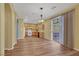 Open-concept living room with hardwood-style floors leading to kitchen and sliding glass doors at 5976 Ancona Dr, Las Vegas, NV 89141