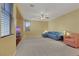 Cozy living room with carpet, a ceiling fan, and natural light from the windows at 5976 Ancona Dr, Las Vegas, NV 89141