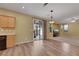 An open-concept living room with sliding glass doors, hardwood-style floors and neutral walls at 5976 Ancona Dr, Las Vegas, NV 89141