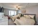 Bedroom with two queen beds, comfortable beige bedding, a fan, and a TV on the wall at 5990 Mcleod Dr, Las Vegas, NV 89120